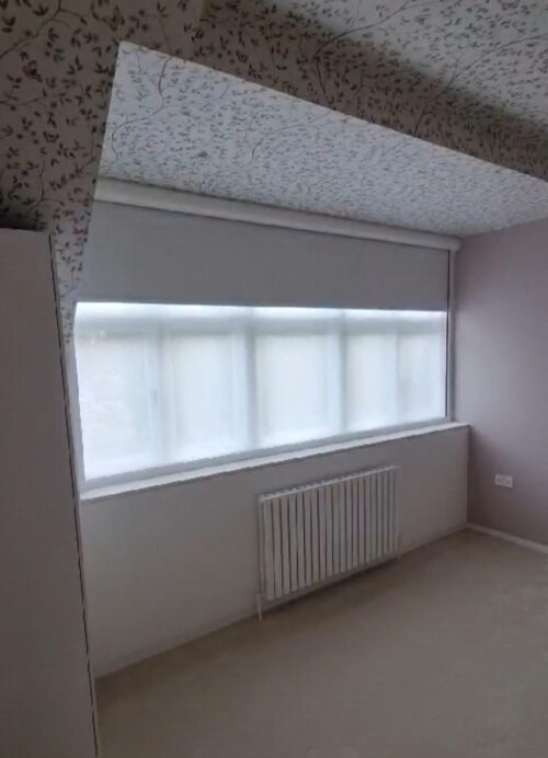 A very wide Fully Cassetted Total Blackout Roller Blind fitted together with a Sheer Privacy Blind