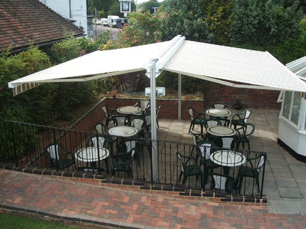 Freestanding Butterfly awning with twin motorised retractable awnings